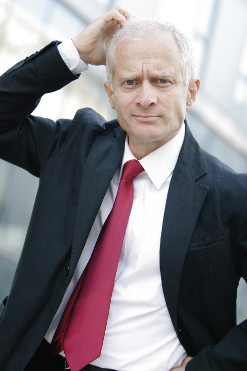 man in suit scratching his head