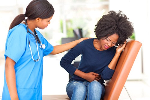 nurse touching a patient in pain