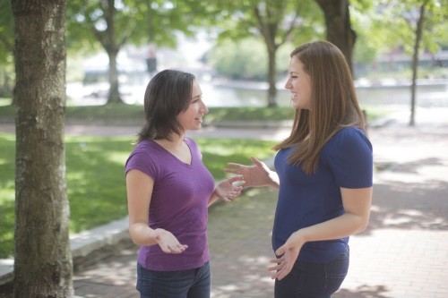 2 women in park listening to each other