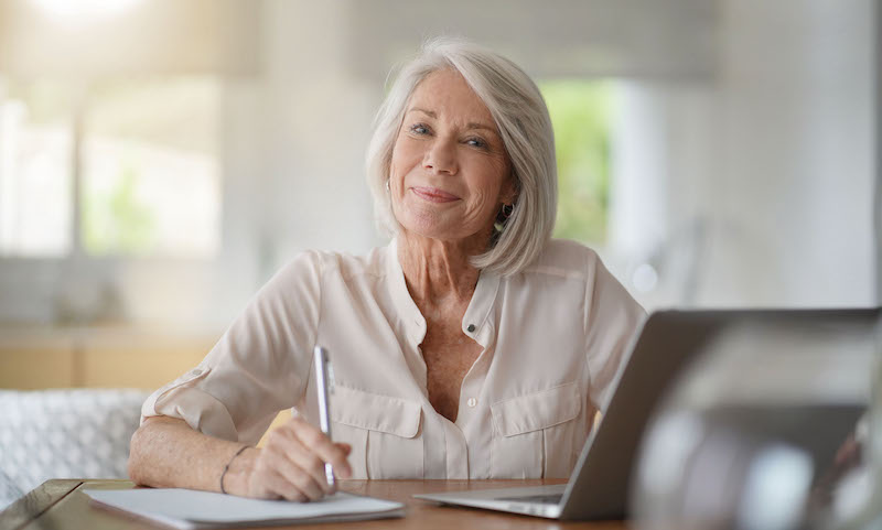 woman smiling writing