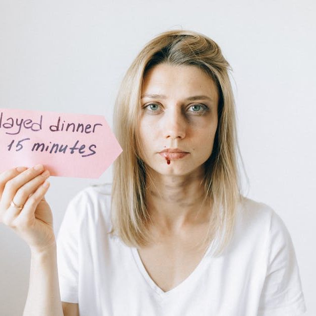 intimate partner violence - woman holding a sign